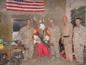 Mark posing with fellow Marines while serving in Iraq.